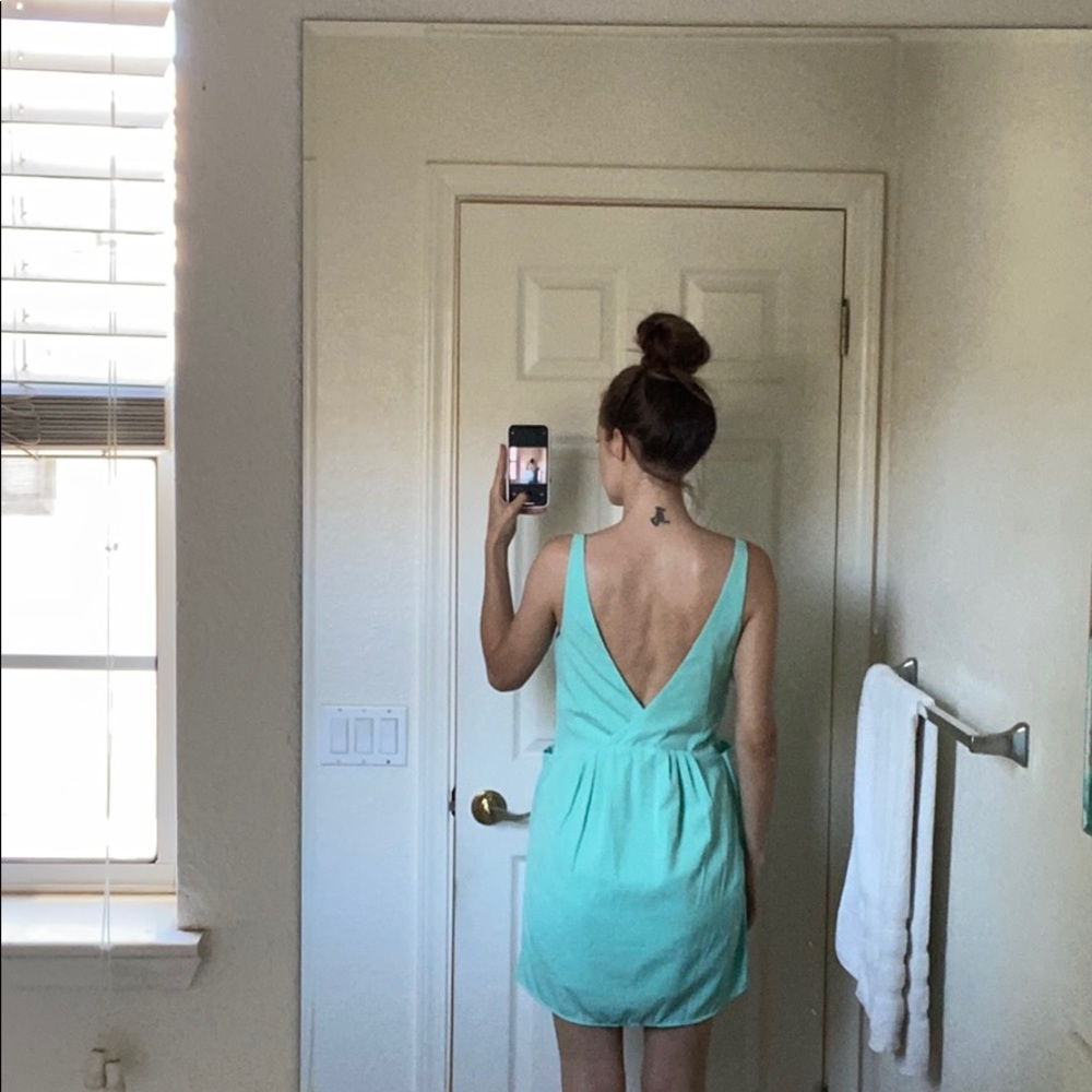 Turquoise open back dress with front pockets